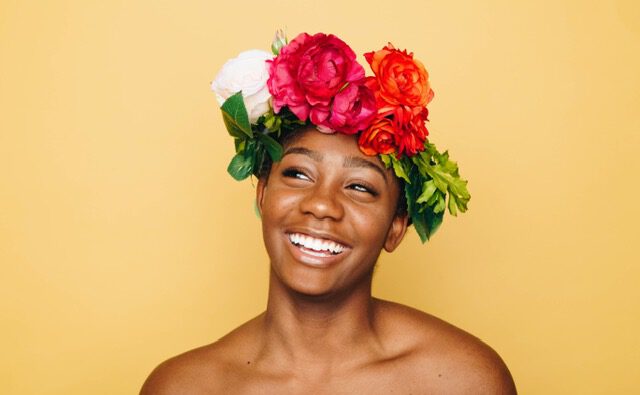 happy african lady with flowers on head thumbnail_Attachment-1